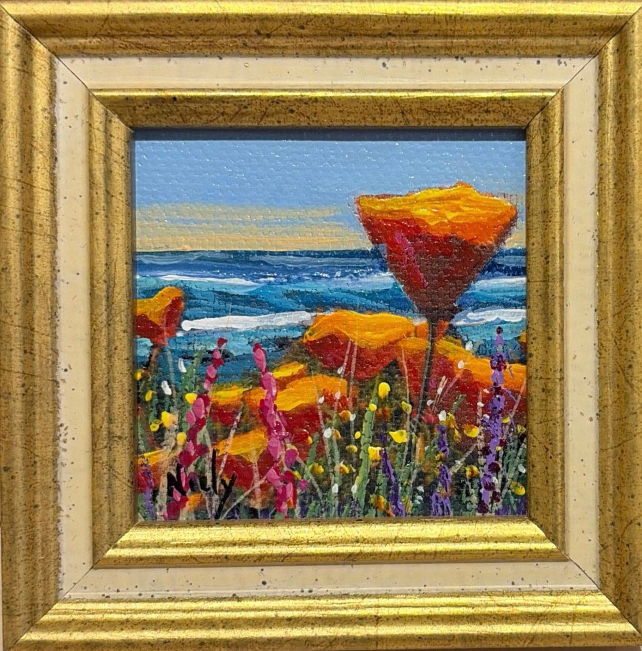 Karen Neely original miniature acrylic painting titled Poppies By the Sea featuring vibrant orange California poppies overlooking a blue ocean, framed in custom Italian moulding.
