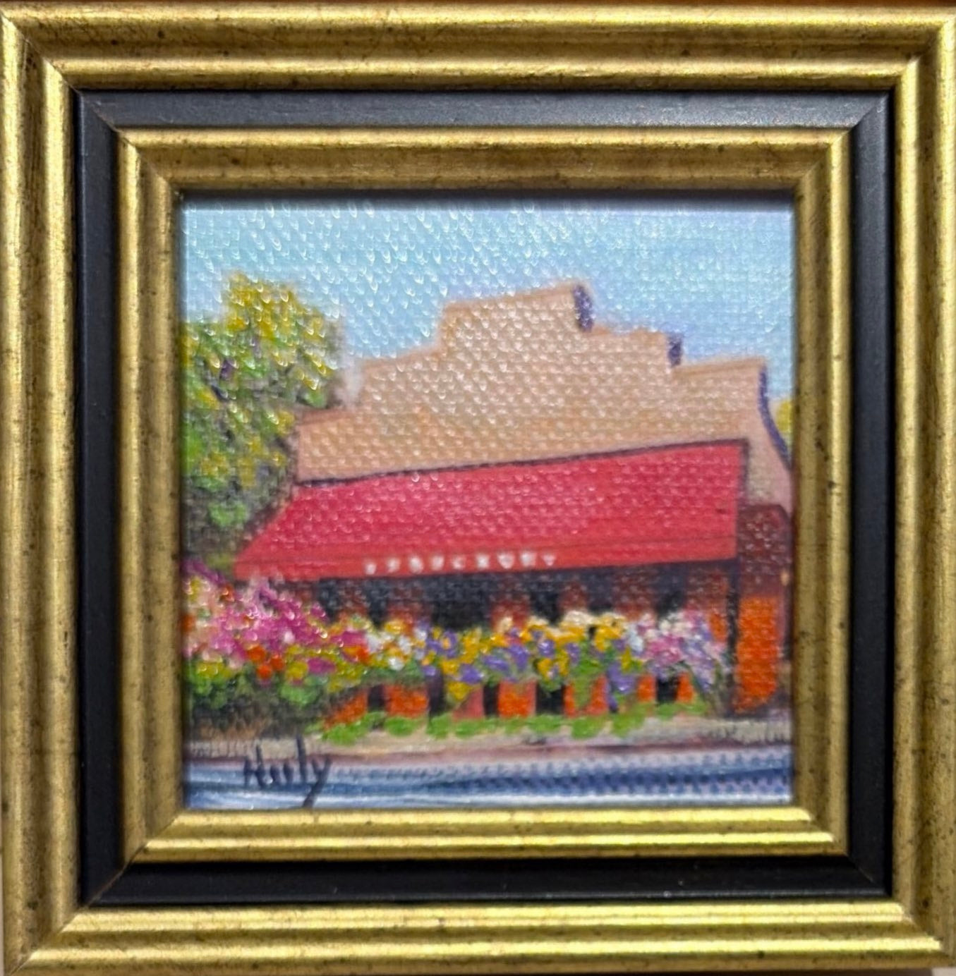 Bouchon Bakery original acrylic painting by Karen Neely featuring the iconic Yountville bakery with its red awning and colorful flower boxes, custom framed in an Italian gold moulding.