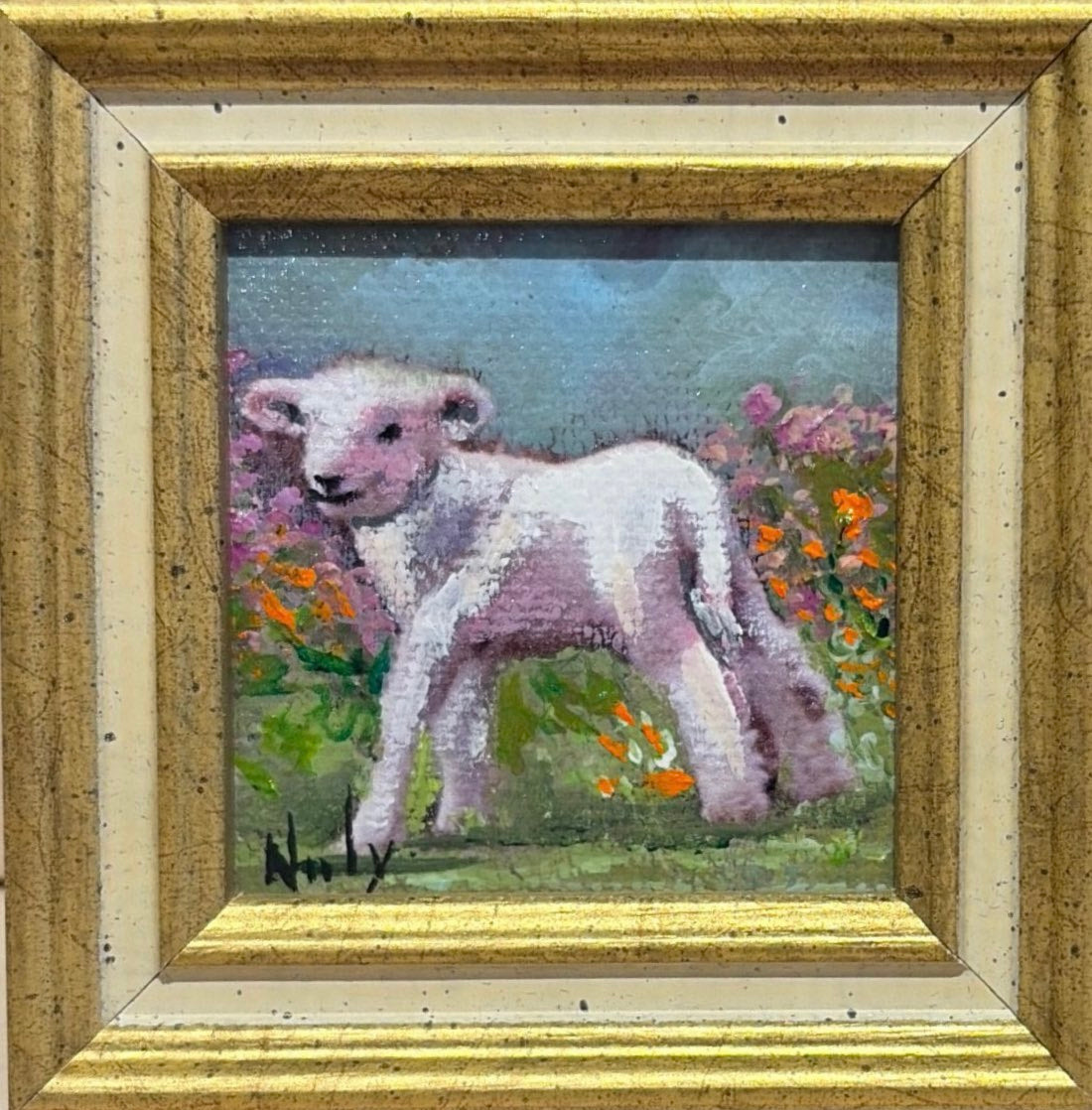 Lamb original acrylic painting by Karen Neely featuring a young white lamb standing among colorful spring wildflowers, custom framed in an Italian gold moulding.