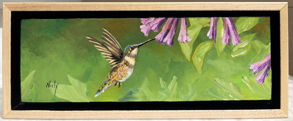 Miniature original acrylic painting “Humming Bird” by Karen Neely, featuring a hummingbird in flight sipping from purple flowers, set in a custom rubbed maple float frame, 3x9 inches (#X157).
