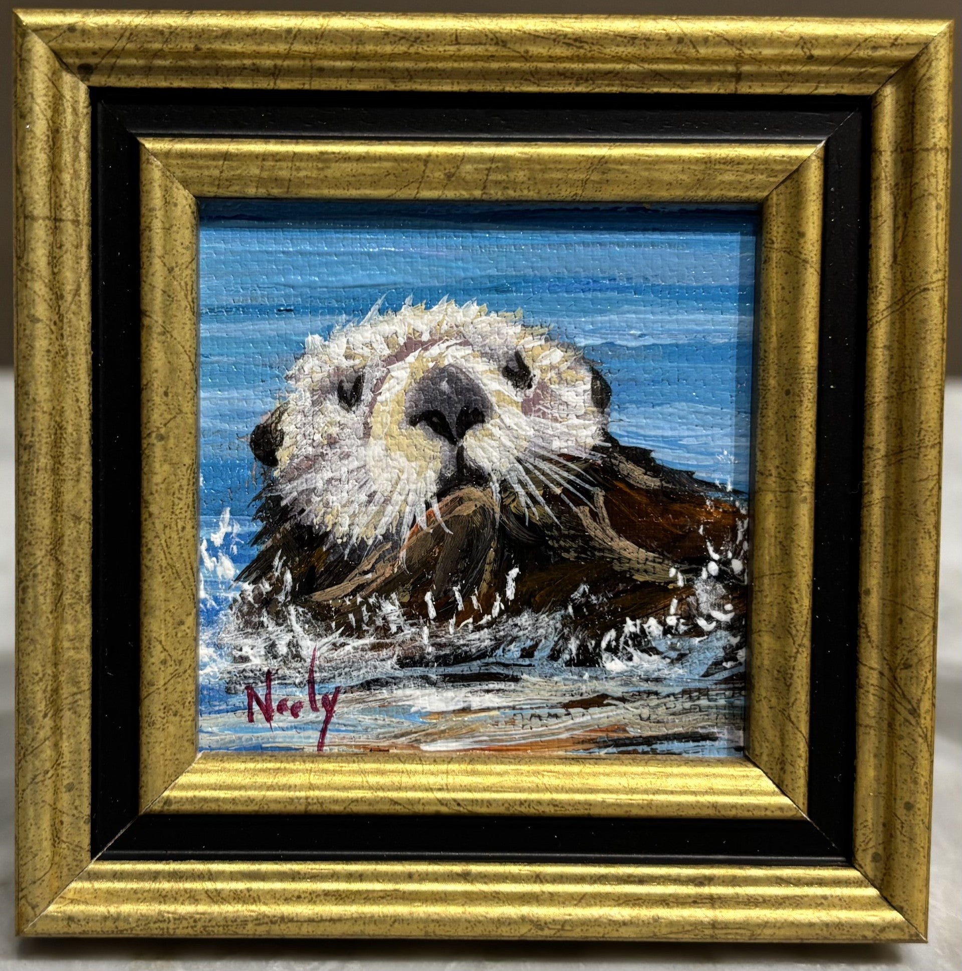 Otter miniature original acrylic painting by Karen Neely (#2M26), otter with kelp splashing in the ocean, framed in imported Italian frame with easel back.