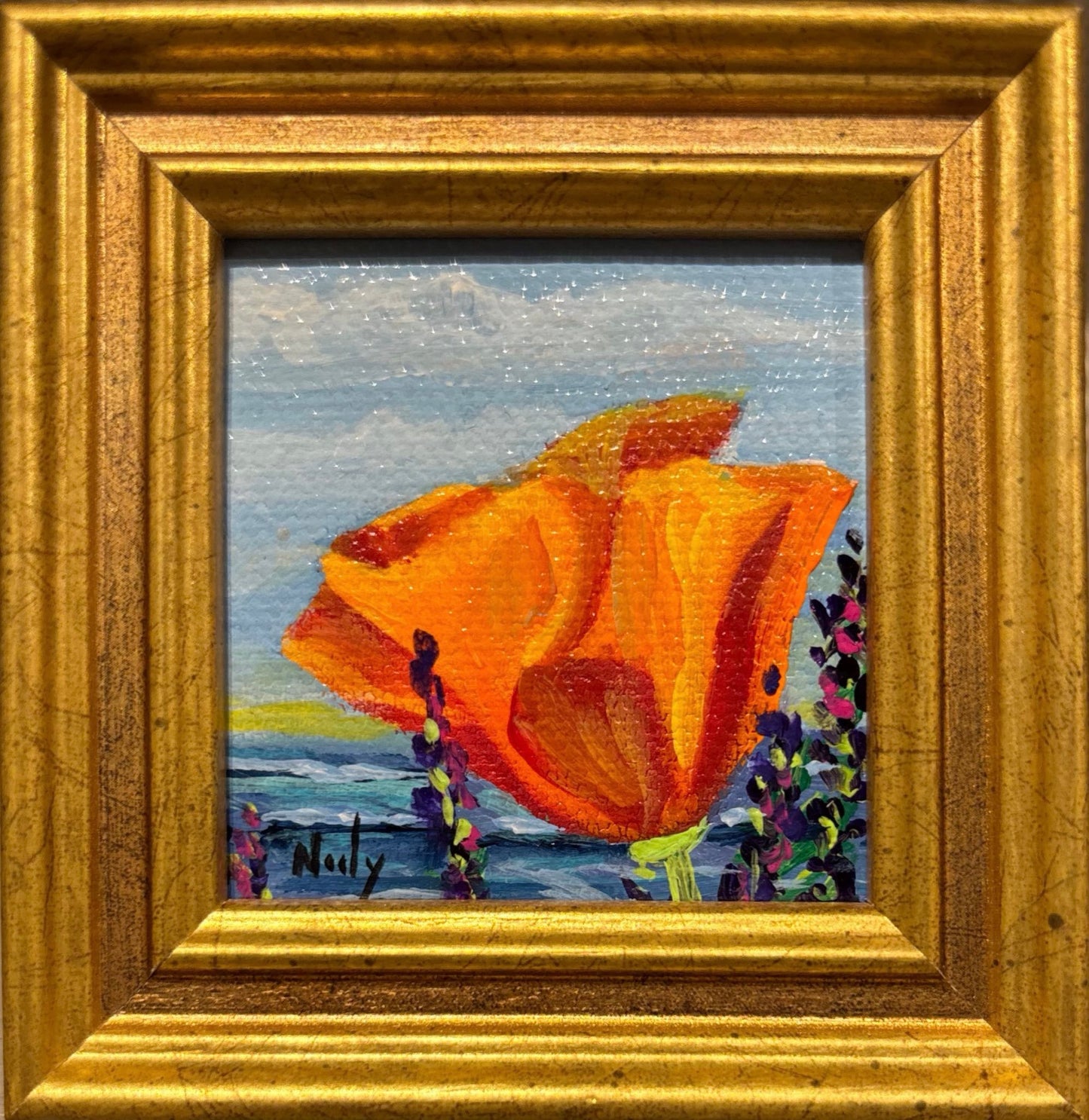 Poppy miniature original acrylic painting by Karen Neely featuring a bright orange poppy flower with a coastal ocean background, framed in gold Italian moulding.