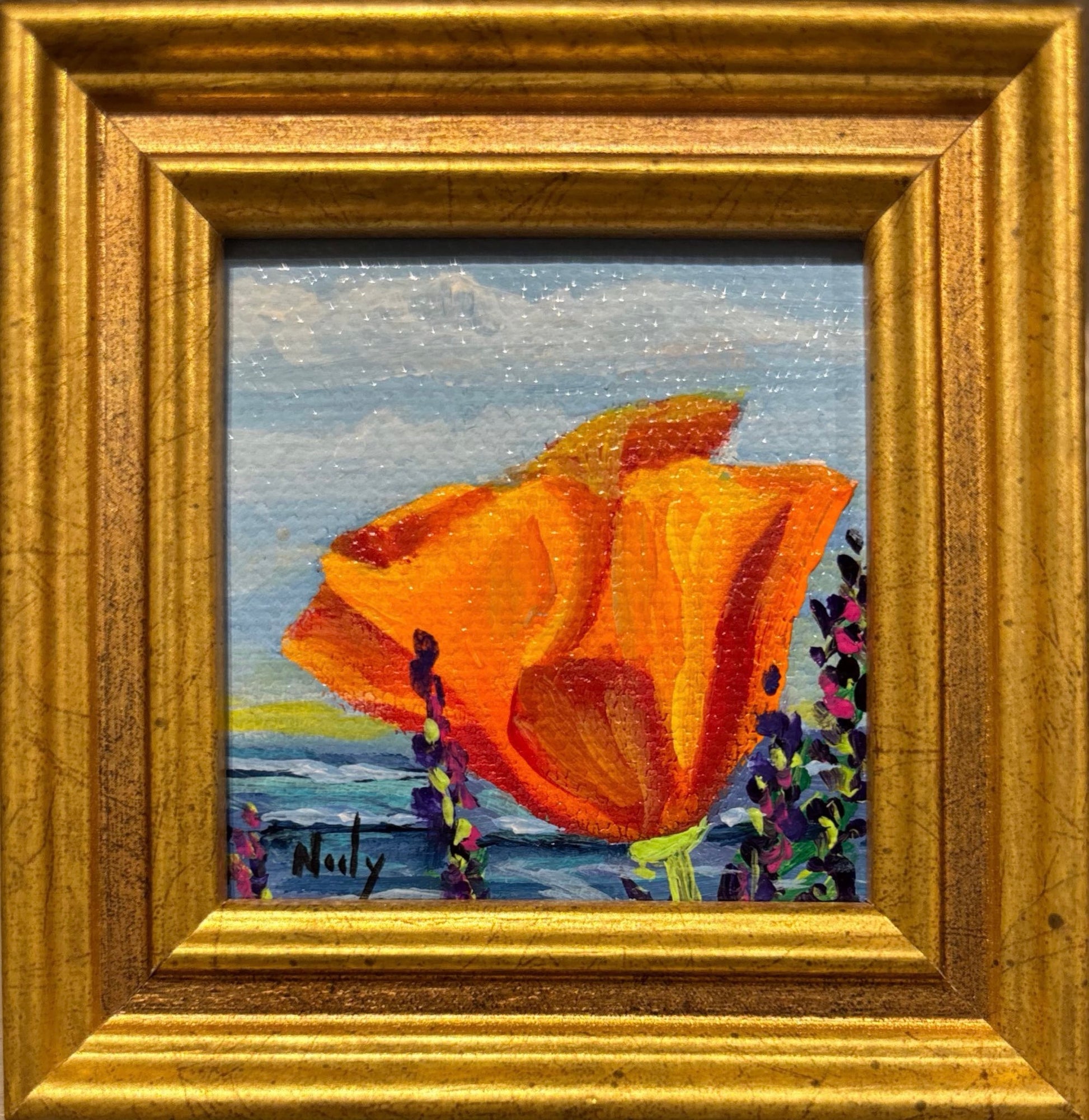 Poppy miniature original acrylic painting by Karen Neely featuring a bright orange poppy flower with a coastal ocean background, framed in gold Italian moulding.
