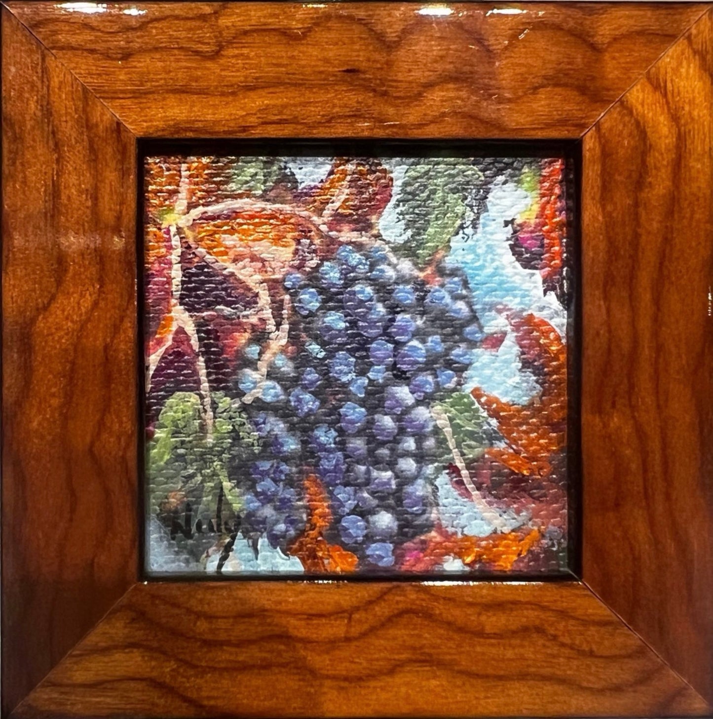 Miniature grapes painting by Karen Neely in burl wood frame hanging on wine bottle