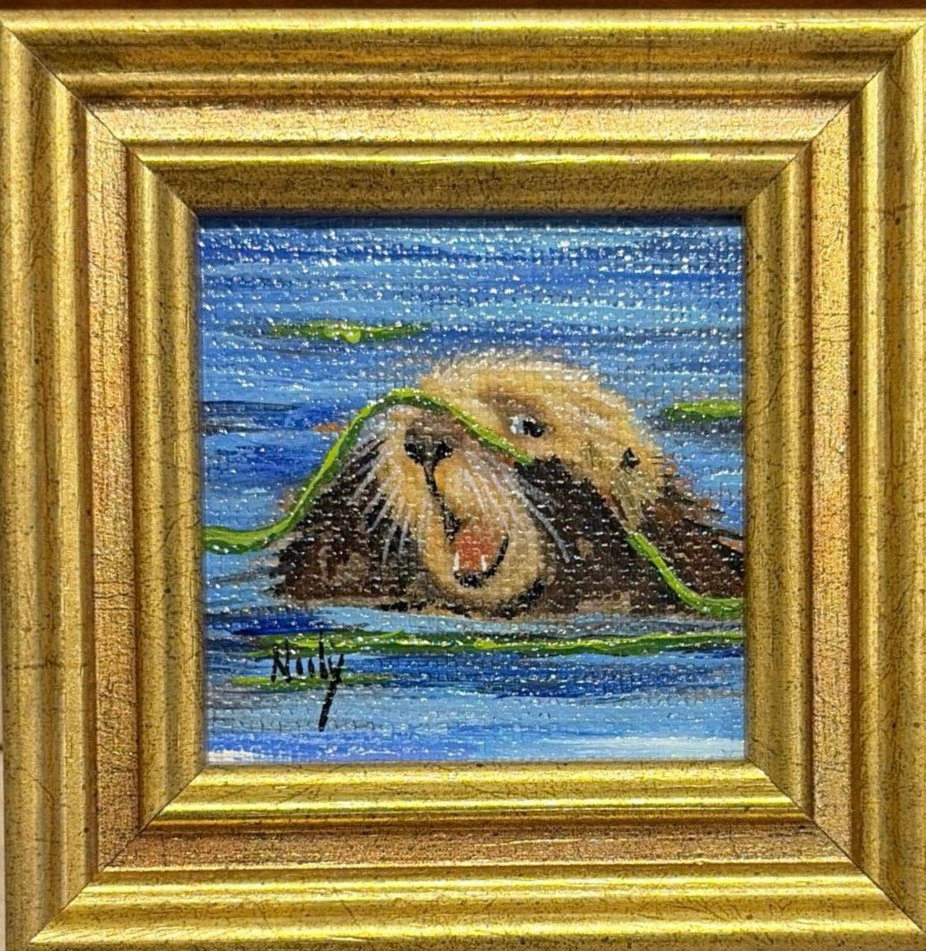 Karen Neely miniature original acrylic painting titled Otter depicting a sea otter floating in blue water with green kelp, framed in a gold custom Italian moulding.
