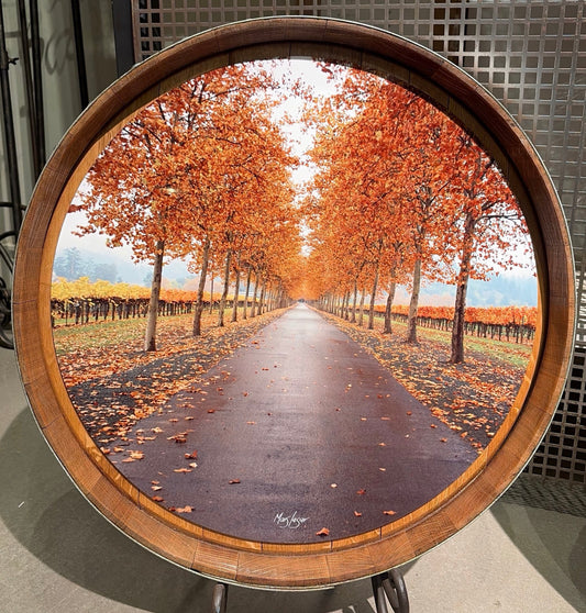 Mars Lasar Fall Leaves barrel top artwork featuring a tree-lined Napa Valley vineyard road covered in vibrant autumn foliage, mounted on an authentic wine barrel top.