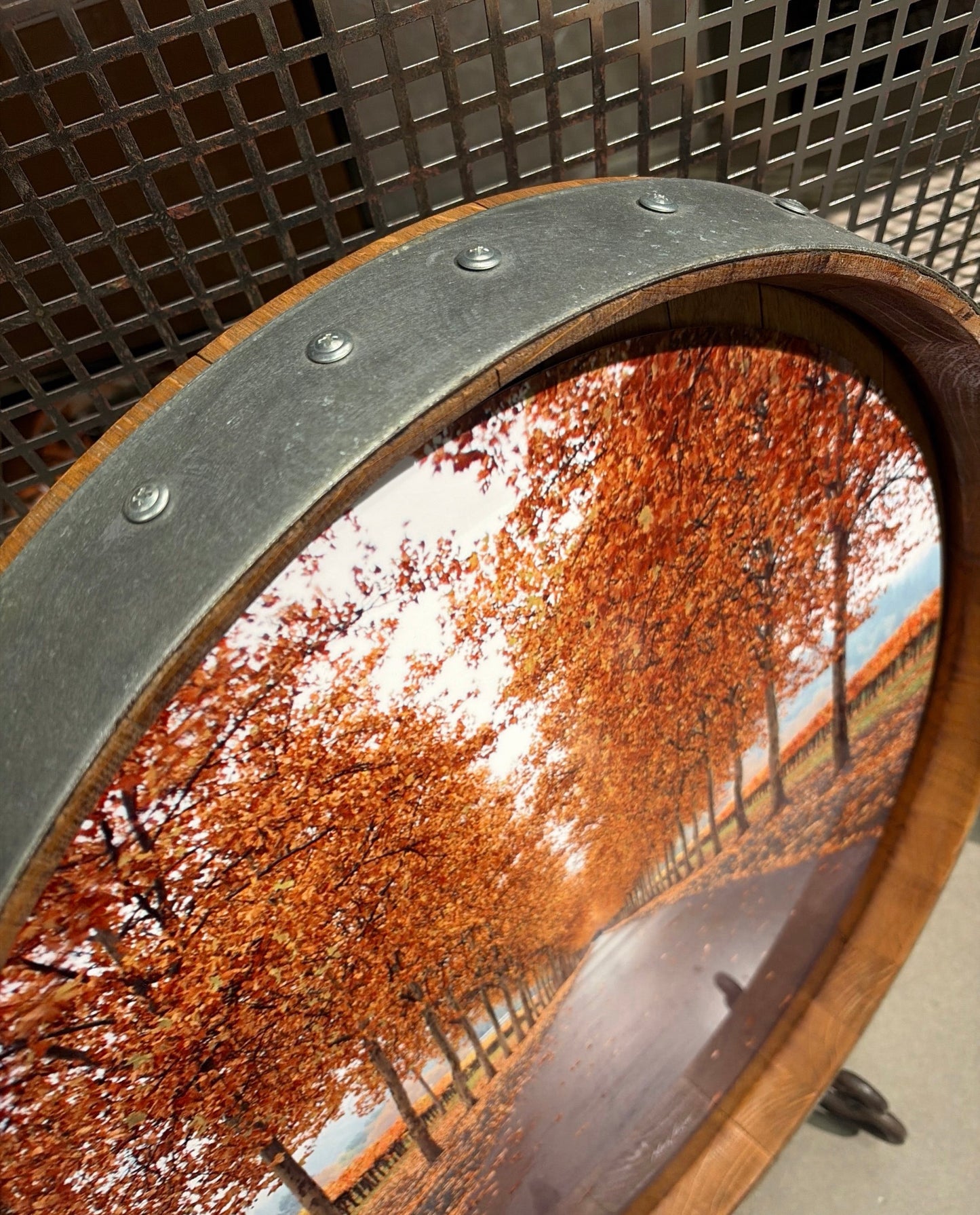 Mars Lasar Fall Leaves barrel top artwork featuring a tree-lined Napa Valley vineyard road covered in vibrant autumn foliage, mounted on an authentic wine barrel top.
