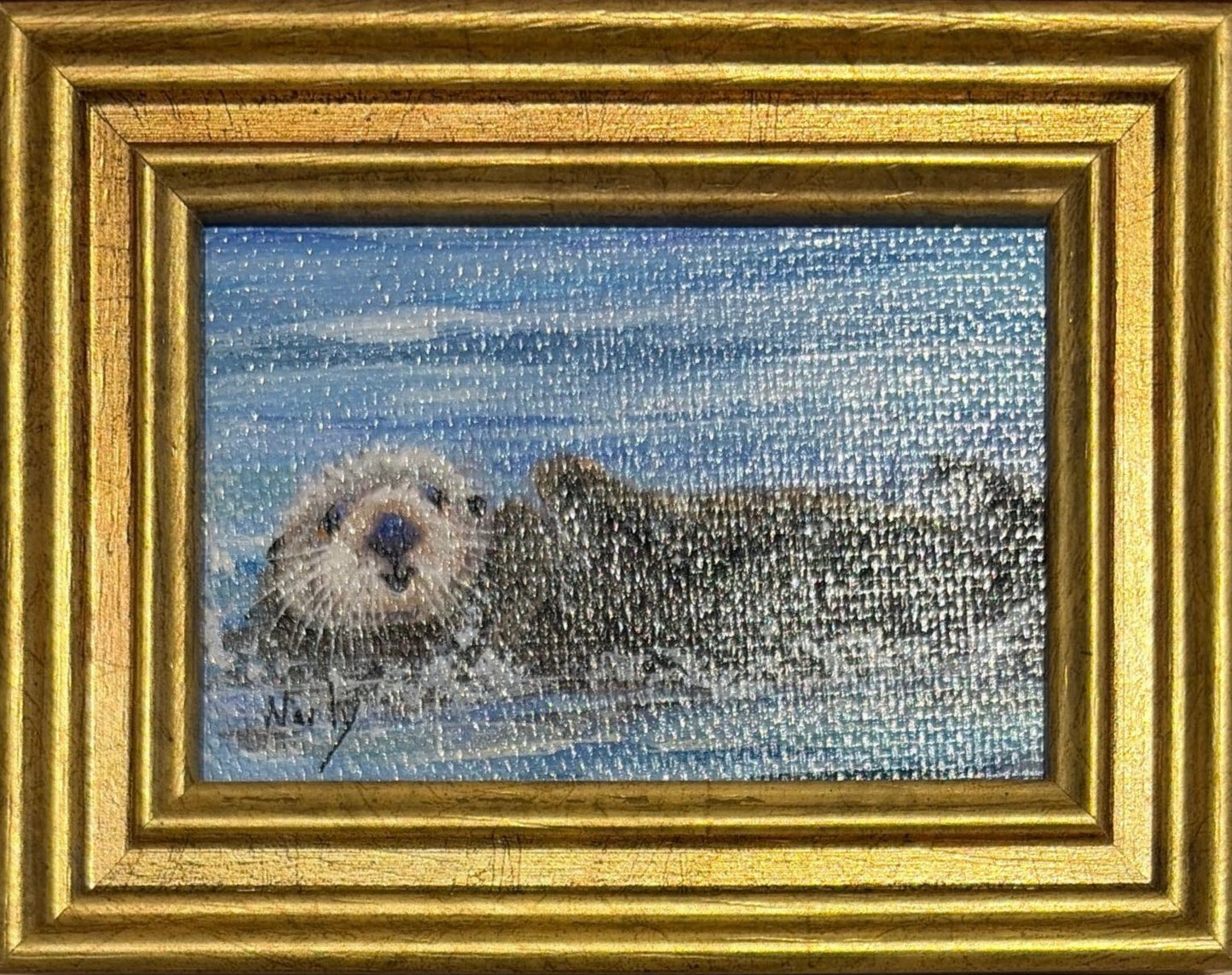 Otter original acrylic painting by Karen Neely featuring a peaceful sea otter floating on calm blue water, custom framed in an Italian gold moulding.