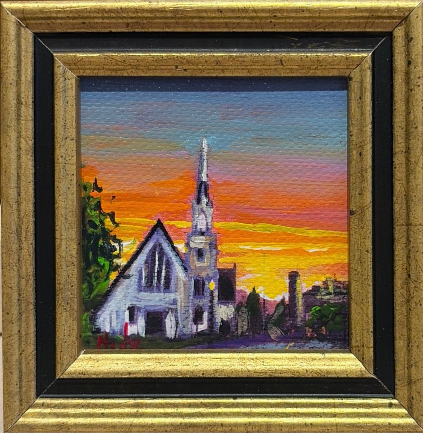 Church original acrylic painting by Karen Neely featuring a white church with a tall steeple beneath a vibrant sunset sky, custom framed in an Italian gold moulding.