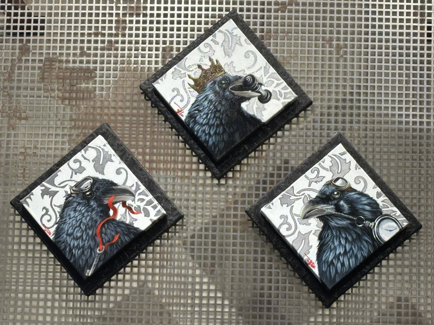 “Triefecta” by Pete Tillack featuring three raven paintings—Checkmate, Key to Success, and On Time.
