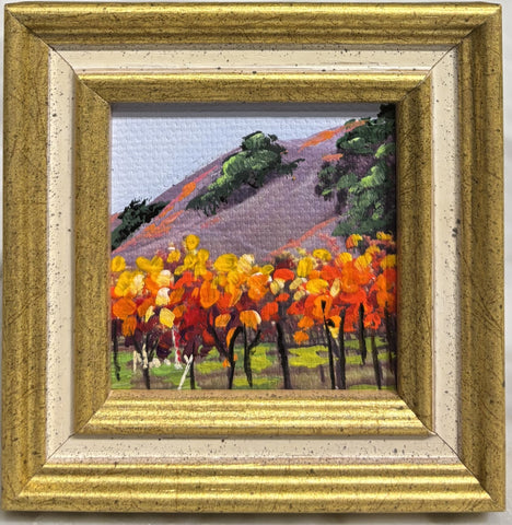 Vineyard miniature original acrylic painting by Karen Neely (#M2150), 2x2", showing colorful vineyard rows against hills, framed in gold Italian moulding (framed size ~3x3").