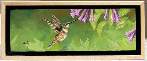 Miniature original acrylic painting “Humming Bird” by Karen Neely, featuring a hummingbird in flight sipping from purple flowers, set in a custom rubbed maple float frame, 3x9 inches (#X157).